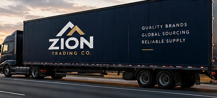 Navy semi-truck trailer with the Zion Trading Co. logo driving on a highway at sunset